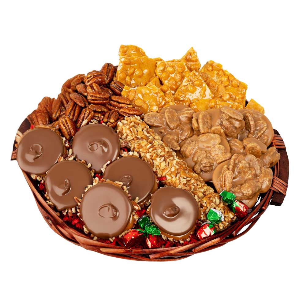 Assorted candy and snack platter including chocolates, nuts, and pralines on a white background