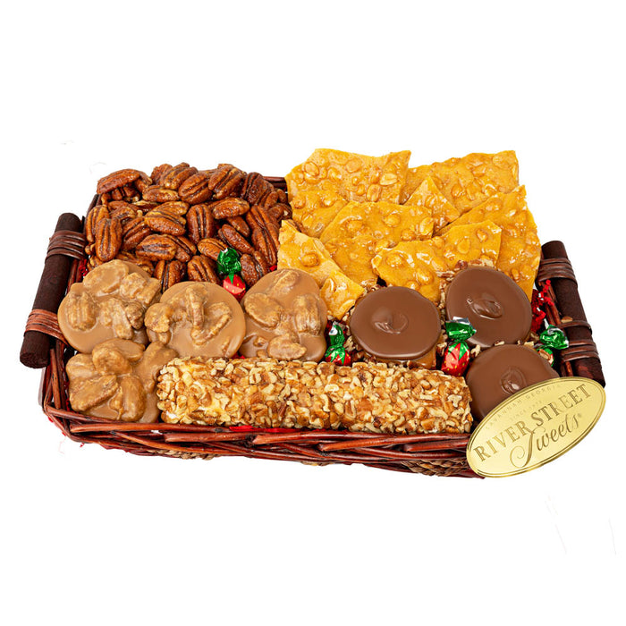 Assorted candies including pecans, toffee, and chocolate in a wicker basket with 'River Street Sweets' label.