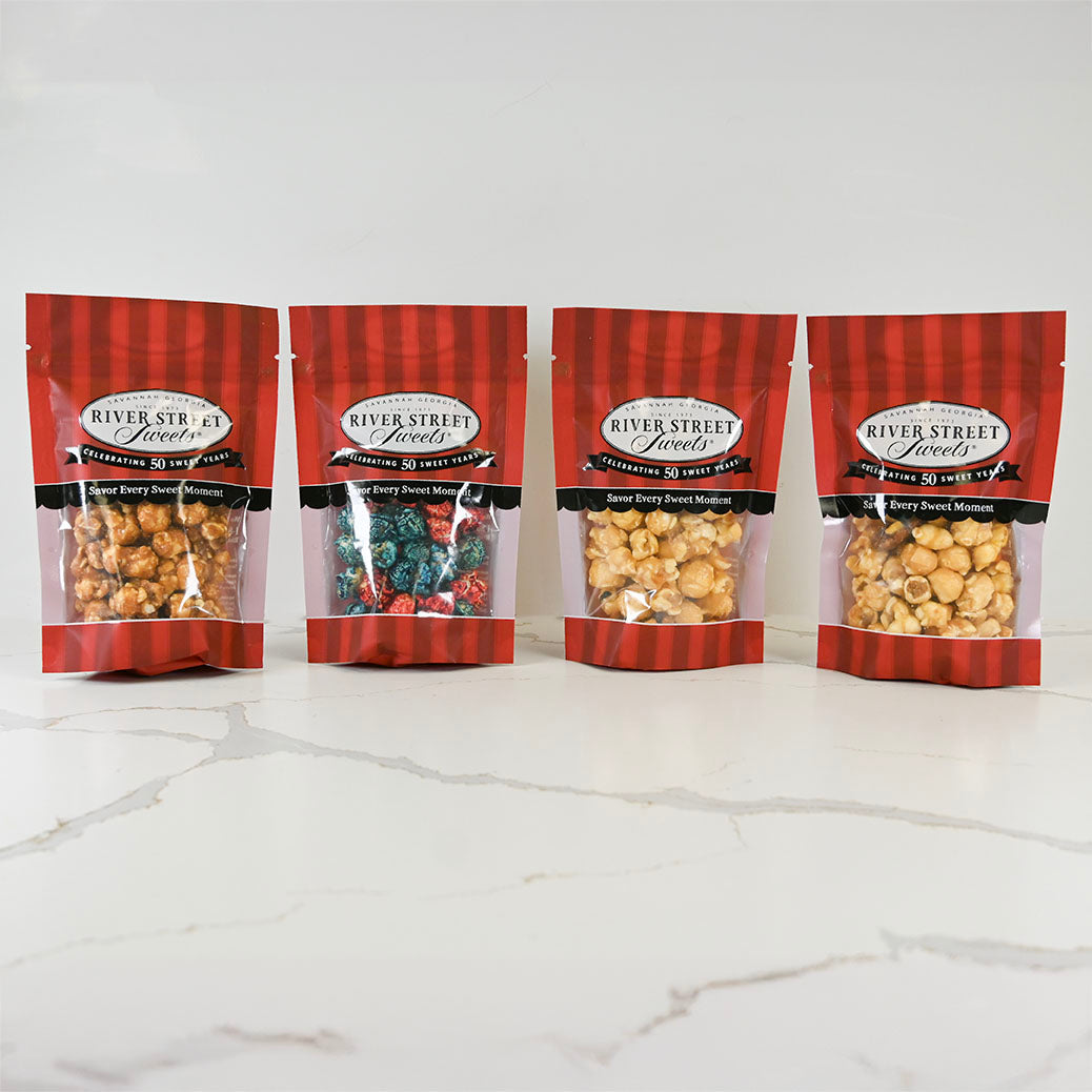 Four bags of River Street Loxelts snacks on a white marble surface