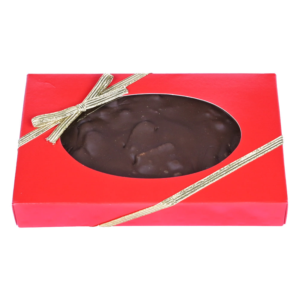 Chocolate pecan fudge in a red box with a clear window and gold ribbon
