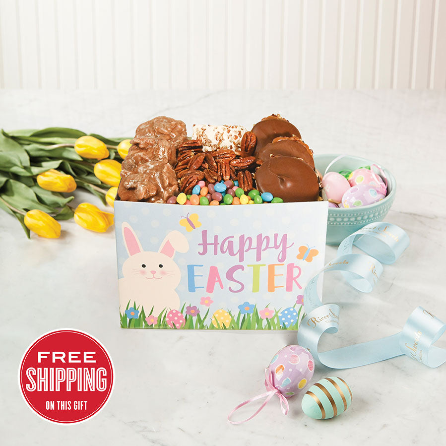 A festive Easter-themed gift box with an assortment of chocolate treats, including pralines and bear claws, alongside colorful Easter eggs and tulips. The box features a 'Happy Easter' design with bunny and Easter egg graphics.