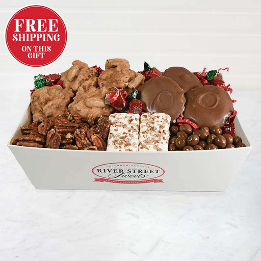 Assorted candy and pralines in a box with 'River Street Sweets' branding on a white background.