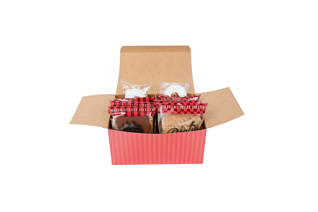 A red striped box with wrapped bear claws, pralines, and divinity peeling out the box