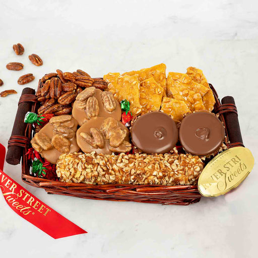 Assorted candy and nut gift basket with a gold tag on a white background