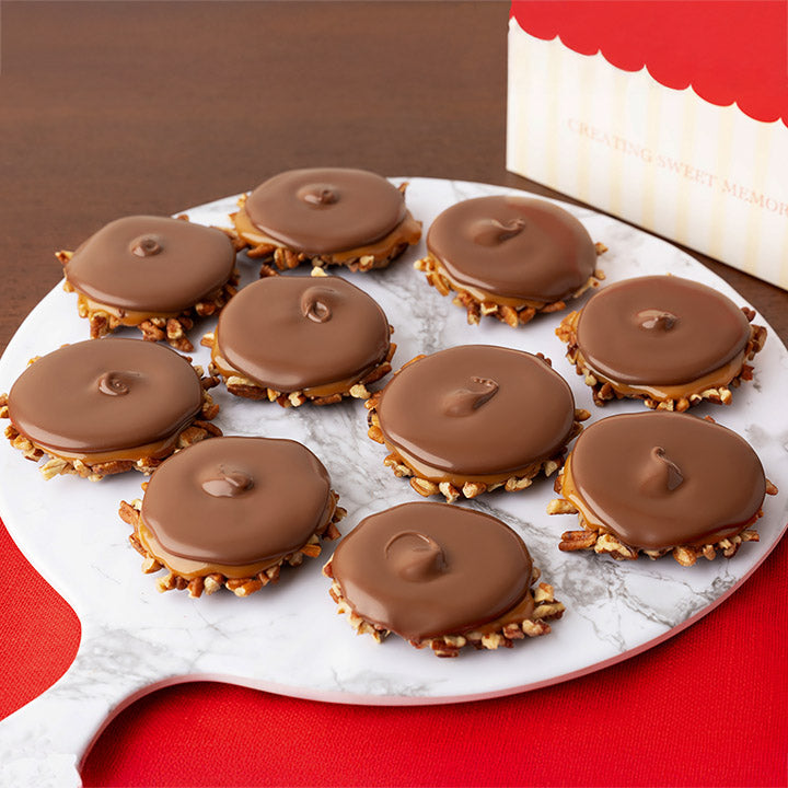 Bear claw candies on a marble tray with a red background