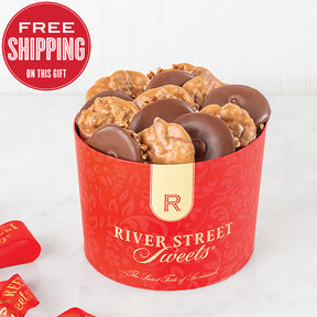 A red container filled with chocolate covered bear claws and pralines. The container has 'River Street Sweets' branding on it.