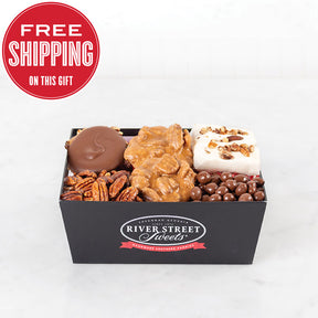 A branded black tray of River Street Sweets Sampler, including pralines, pecans, and other Southern-style sweets.