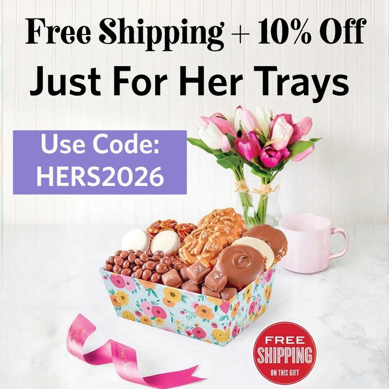 Promotional image of a gift tray with candies, a mug, and flowers, featuring text for free shipping and a discount code.