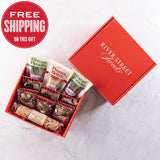 An open red gift box displaying an assortment of chocolate and nut based confectionery items, with a promotional offer of free shipping.