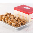 A box of Savannah's World Famous Pralines with the text 'CREATING SWEET MEMORIES' on the box. The pralines are displayed in front of the box on a white plate.