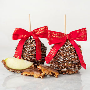 Bear Claw Caramel apples with red ribbons and 'River Street Sweets' branding on a light background