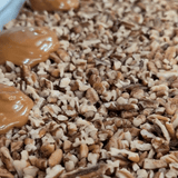 Caramel dripping on chopped pecans nd then topped with chocolate