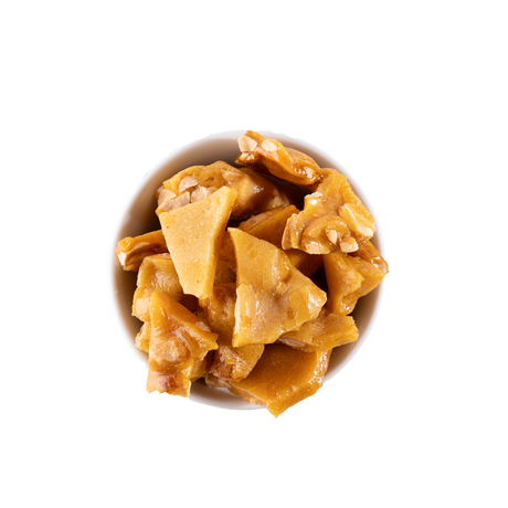 Peanut brittle in a white bowl