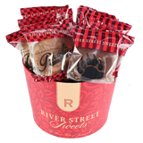 Wrapped pralines and bear claws in a red "River Street Sweets" tub