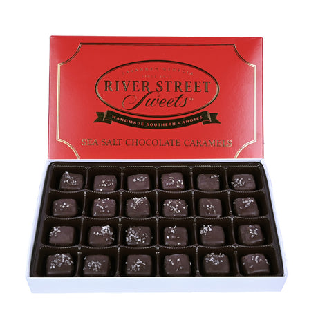 Dark chocolate sea salt caramels in a white box with the red lid propped up behind