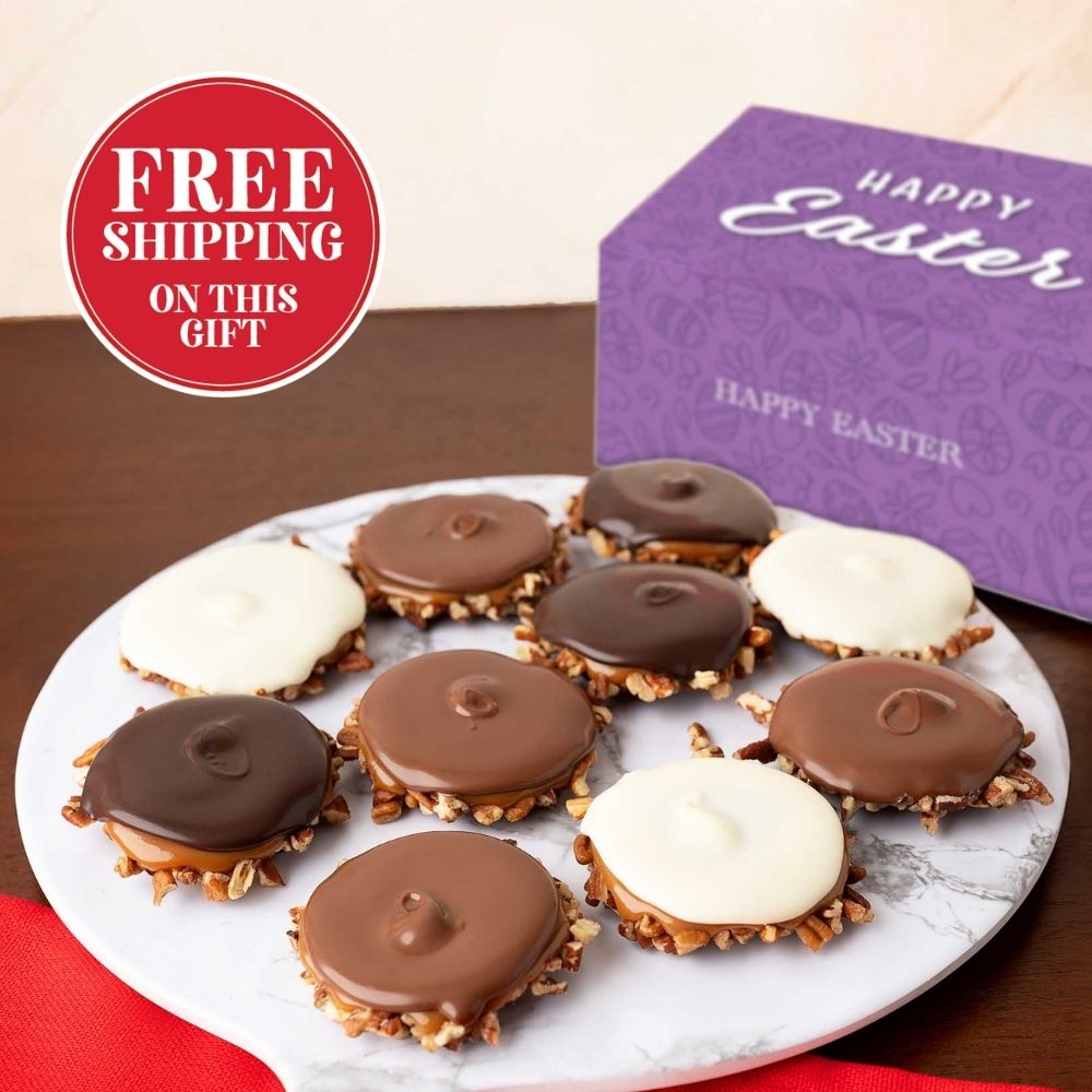 Plate of assorted bear claws with a purple 'Happy Easter' box on a brown surface.