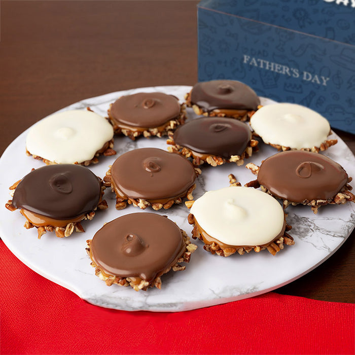 Plate of assorted chocolate bear claws with a 'Father's Day' themed box in the background.