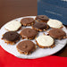 Plate of assorted chocolate bear claws with a 'Father's Day' themed box in the background.