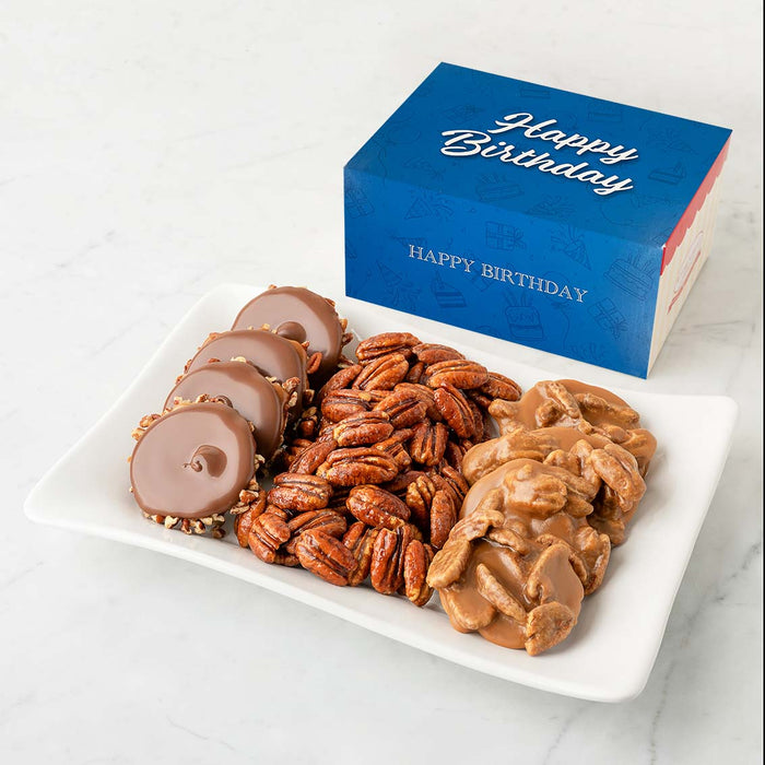 Assorted candies and nuts on a plate with a 'Happy Birthday' box in the background.