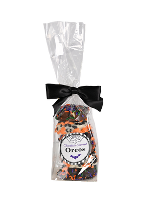 Chocolate covered oreos with Halloween themed sprinkes in a clear bag with a black bow