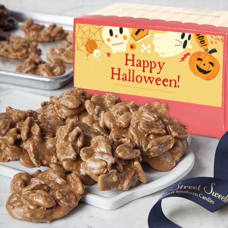 Pralines on a white plate with a Halloween-themed box in the background