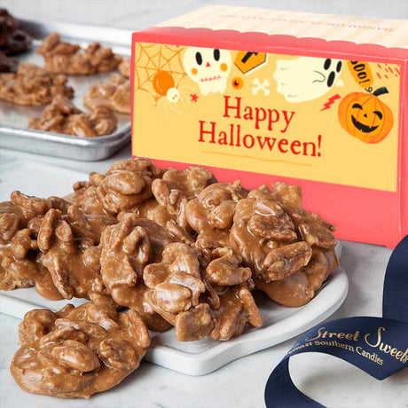 Pralines on a white plate with a Halloween-themed box in the background