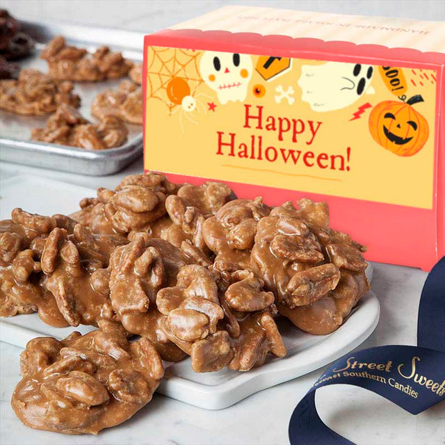 Pralines on a white plate with a Halloween-themed box in the background