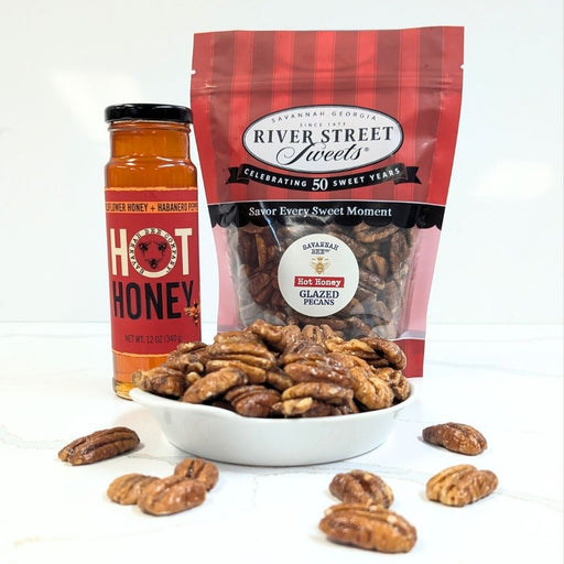 Jar of hot honey and bag of River Street Sweets hot honey glazed pecans on a white background