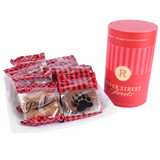 Packaged Pralines and Bear Claws beside a red "River Street Sweets" canister