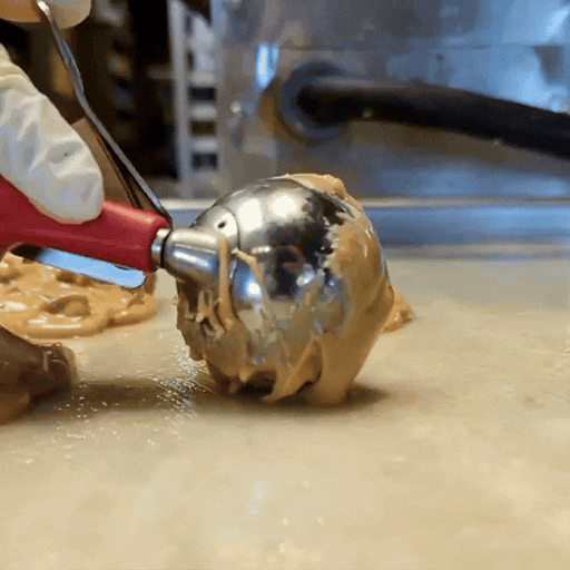 Praline being dipped on the marble