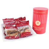 Packaged Pralines on a plate beside a red "River Street Sweets." canister