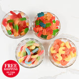 Four glass bowls filled with colorful gummy candies on a white background, with a free shipping label.