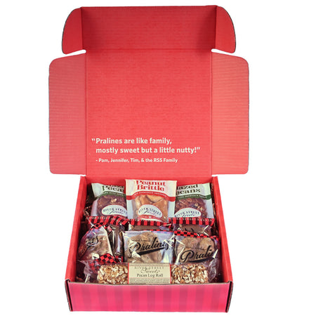 Assorted candies in a red box with the lid open on a white background