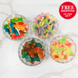 Four glass bowls filled with colorful gummy fish on a white marble surface, with a 'Free Shipping On This Gift' badge in the corner.