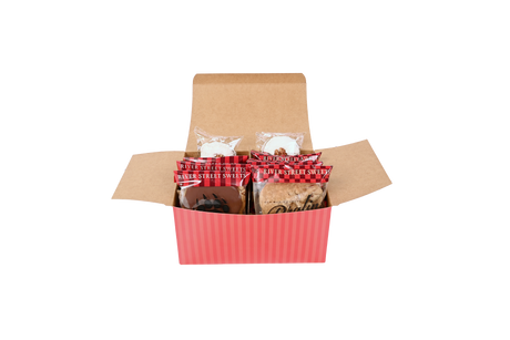 A red striped box with wrapped bear claws, pralines, and divinity peeling out the box