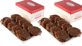 Two trays of bear claws with red and white boxes in the background