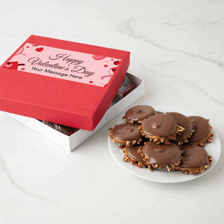 Red Valentine's Day gift box with a plate of chocolate bear claws on a white surface