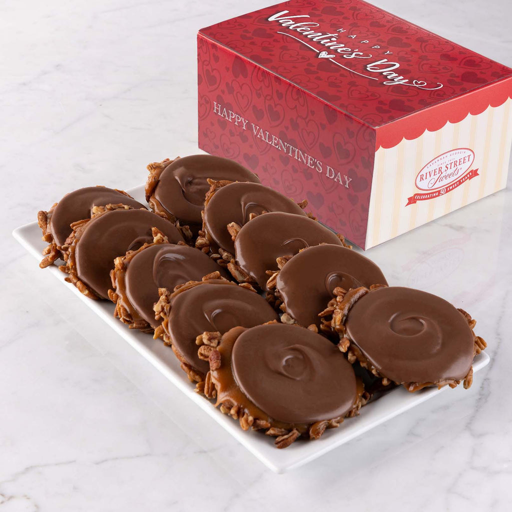 Bear Claws on a white plate with a Valentine's Day-themed box in the background.