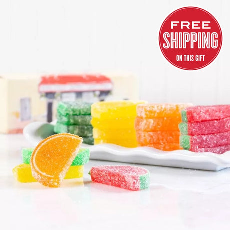 A variety of colorful candy slices displayed, including orange, yellow, green, and red, with a label in the upper right corner stating 'FREE SHIPPING ON THIS GIFT'.