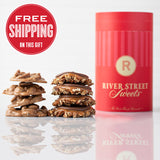 A red cylindrical canister labeled 'River Street Sweets' with a stack of praline and bear claw in front of it, and a 'Free Shipping' text overlay at the top.