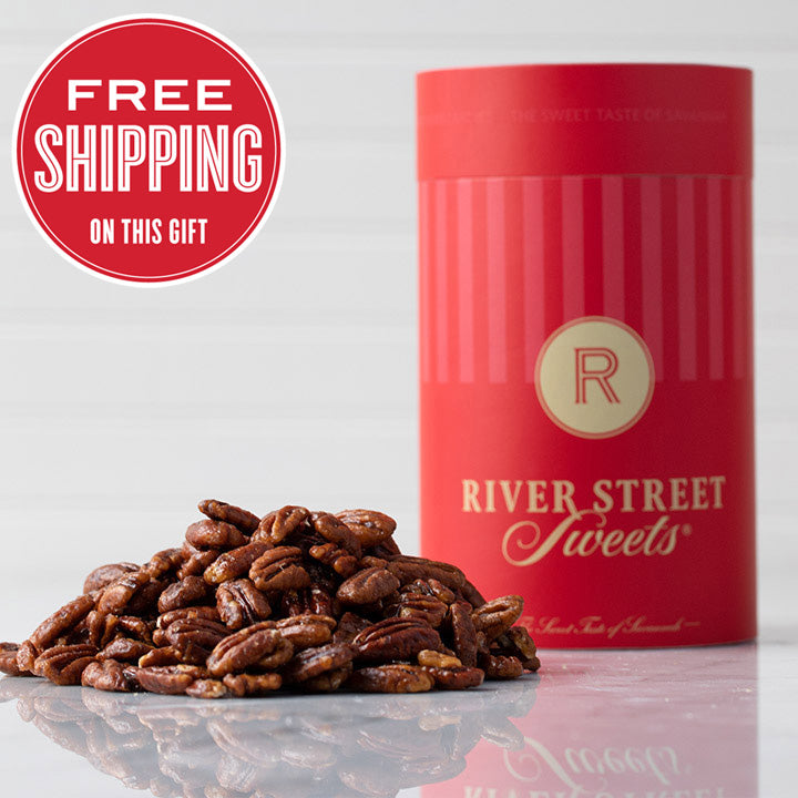 A red cylindrical canister labeled 'River Street Sweets' with a pile of glazed pecans in front of it. There is a 'Free Shipping' text overlay at the top left of the image.