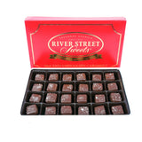 Milk chocolate caramels in a white box with the red lid propped behind it