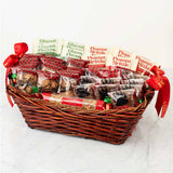 Gift basket with assorted treats including peanut brittle and glazed pecans on a white background