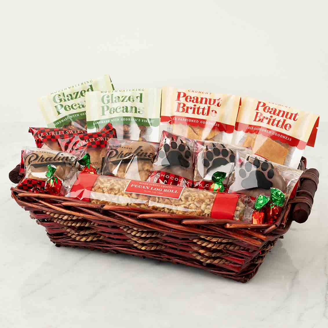 Gift basket with various snack items on a white background