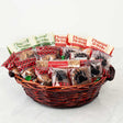 Basket of assorted sweet treats with visible packaging on a white background