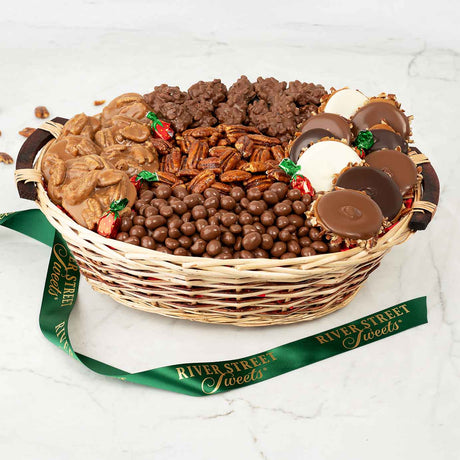 Wicker basket filled with assorted chocolates and candies, branded 'River Street Sweets', on a white background.