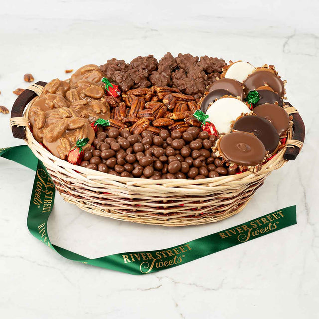 Wicker basket filled with assorted chocolates and candies, branded 'River Street Sweets', on a white background.
