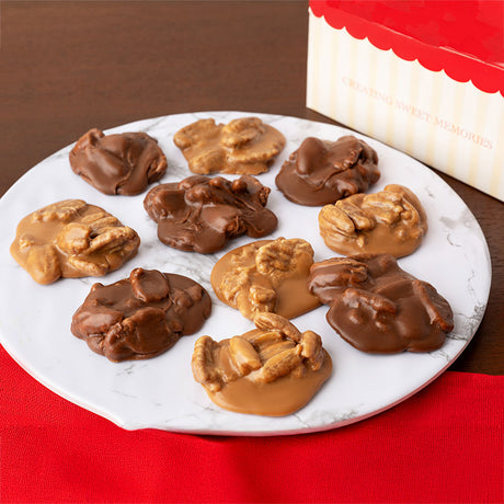 Assorted pralines on a white plate with a red box in the background.