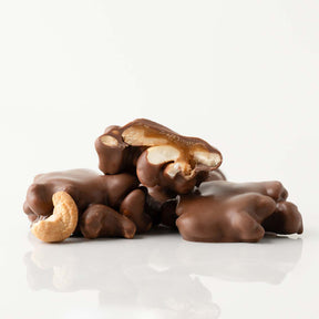 Chocolate-covered cashews on a white background