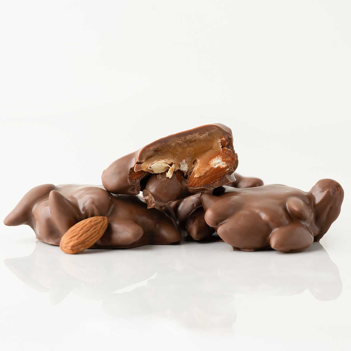 Chocolate-covered almonds on a white background